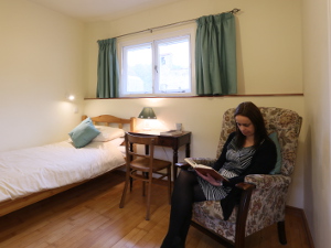 guest relaxing in an Abbey Garth bedroom